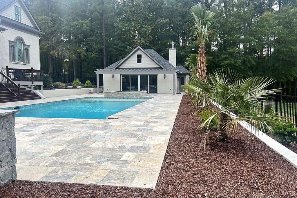 a pool in a backyard with a patio