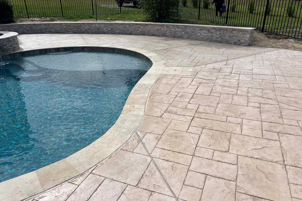 a freeform pool in the backyard patio of a home
