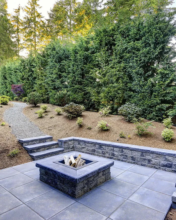 a rectangular fireplace with stone stairs