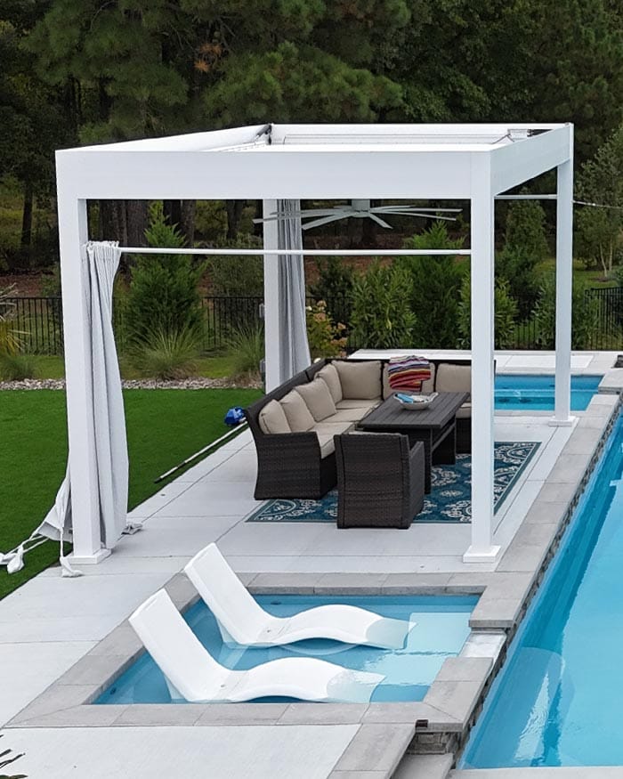 a pergola above a pool patio